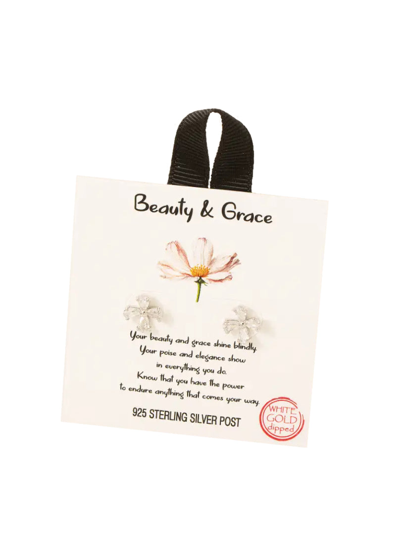 A pair of flower stud earrings, outlined in silver.