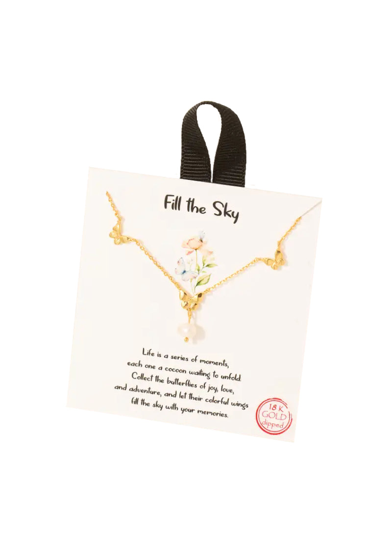 Gold chain necklace with three gold butterfly charms and a pearl dangling from the center butterfly.