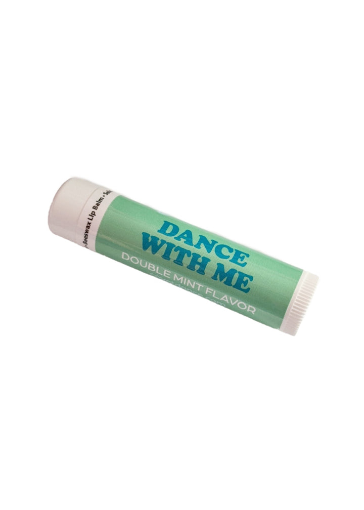 Green tube of lip balm with text "DANCE WITH ME."
