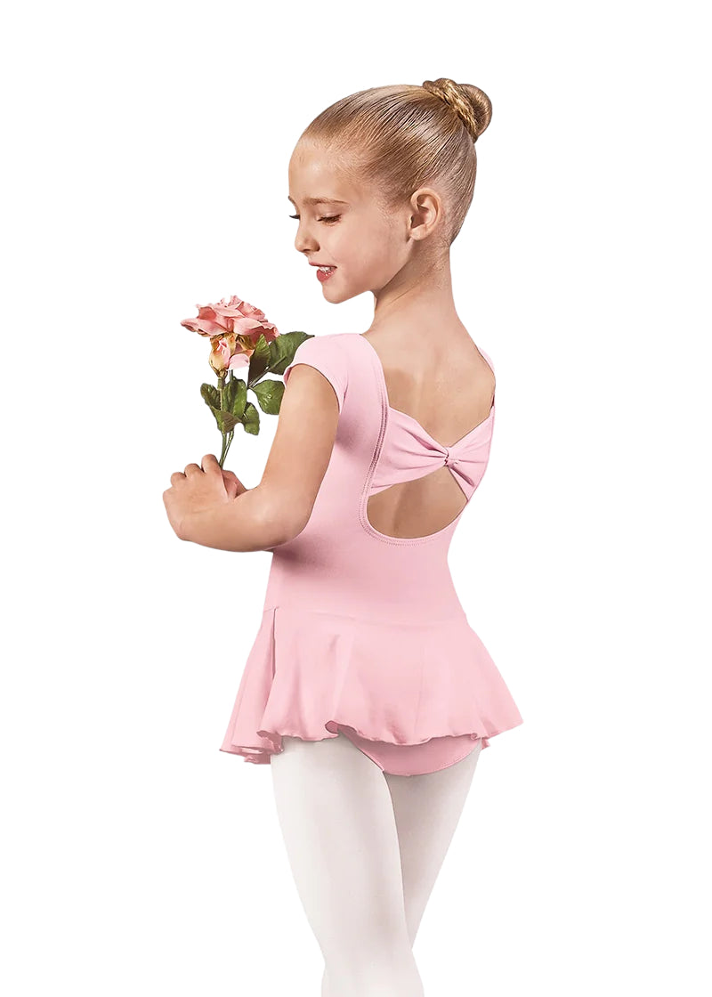 44285 Eurotard Girls Microfiber Bow Back Cap Sleeve Dance Dress in Pink, shown from the back on an adorable young dancer, who is holding a pink flower and looking over her left shoulder towards the viewer