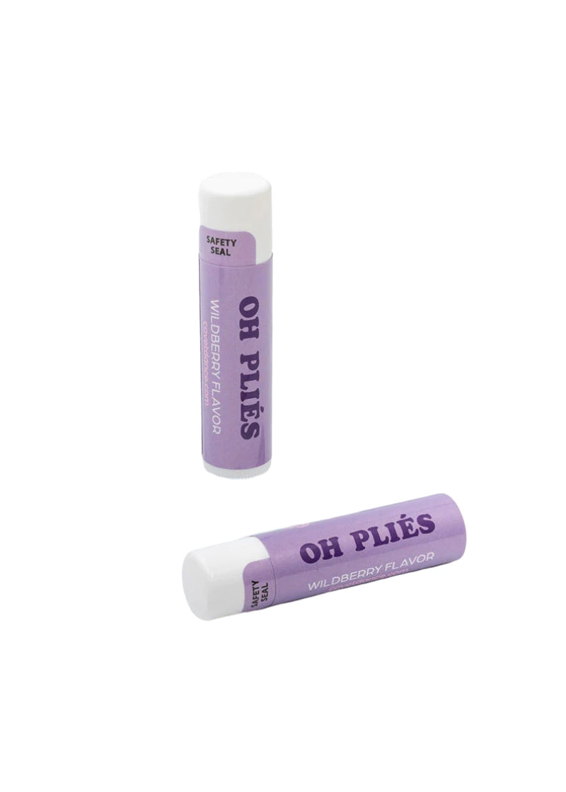 Two purple lip balm tubes with "oh pliés" written on them.