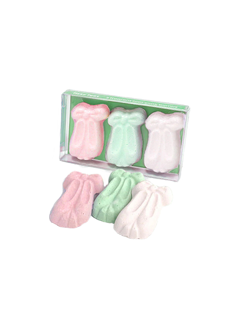 Two sets of three pointe-shoe shaped bath bombs. One is pink, one is green, and one is white.