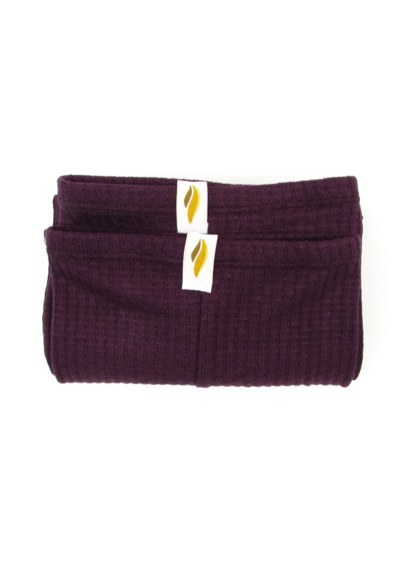 A folded pair of dark reddish-purple legwarmers.