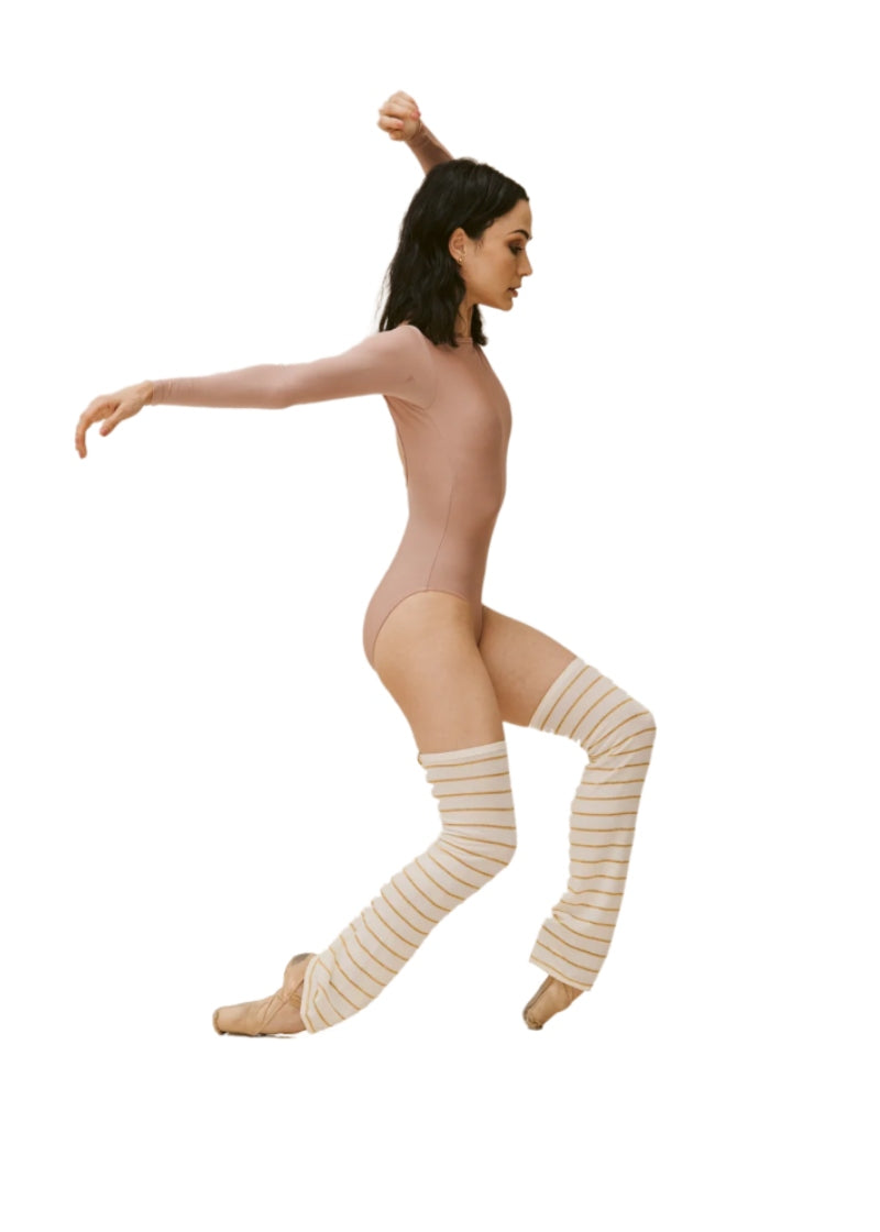 Above the knee cream-colored legwarmers with thin gold stripes and a relaxed fit at the ankle.