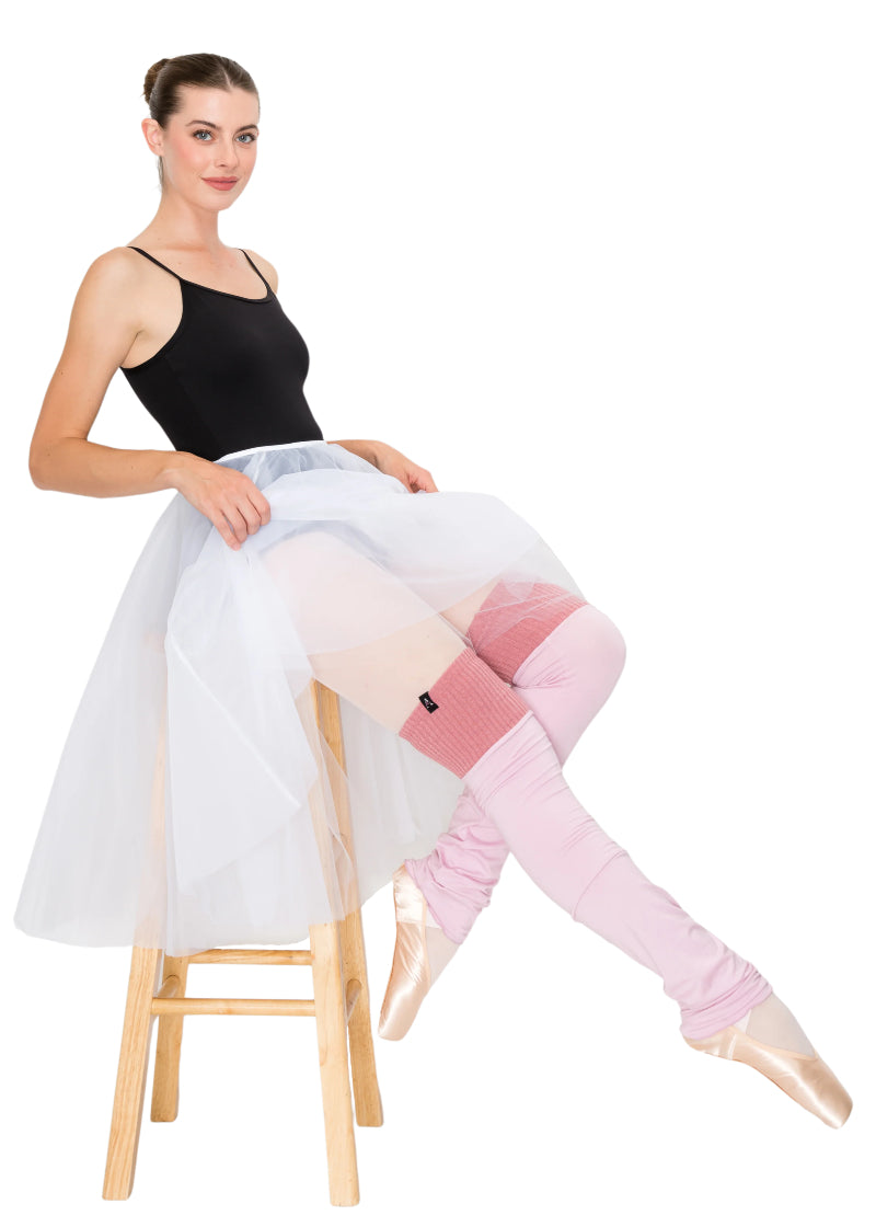 Aluvie women's Aura knee-high legwarmers in light pink with dark pink band above the knee.