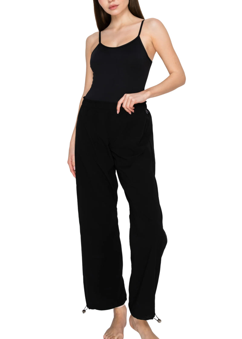 Aluvie women's Bree pants in black with cinched waistband and drawstring hems.