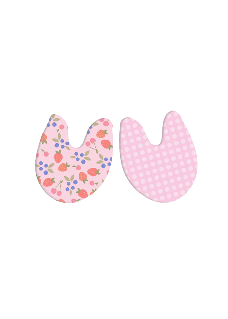Pink toe pads, one printed with berried and one printed with checkered pattern.