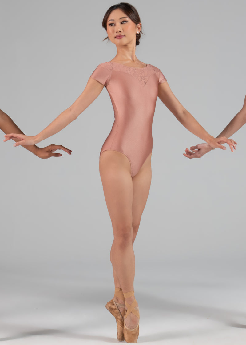 Ballet Rosa 1323LBA Women's Colette Cap Sleeve Leotard in Pearl peachy pink with lace V-neckline, modeled by a ballet dancer en pointe