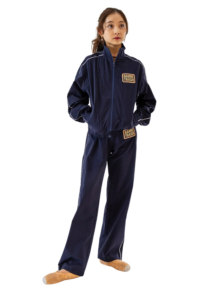 Barre Trash Tracksuit Pants in navy blue with elastic waistband, drawstring leg opening, and pinstripe details