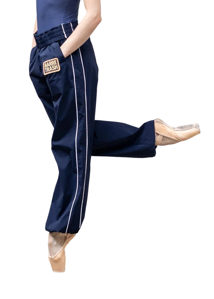 Barre Trash Tracksuit Pants in navy blue with elastic waistband, drawstring leg opening, and pinstripe details