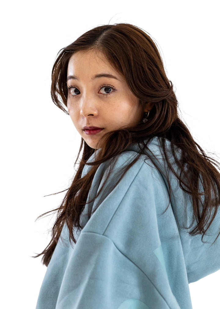 Barre Trash OH Oversized Hoodie in Powder Blue with tone-on-tone lettering, modeled by a ballet dancer