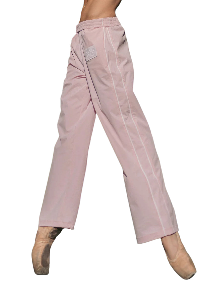 Barre Trash TSP Tracksuit Pants in Ballerina Pink, modeled on a ballet dancer