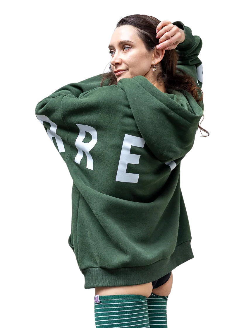 Barre Trash OH Women's Oversized Hoodie in Emerald Green with white Barre Trash logo across the sleeves and back, modeled by a ballet dancer