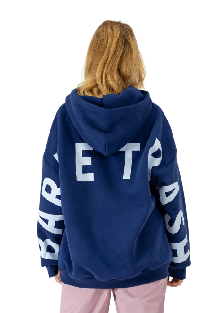 Barre Trash OH Women's Oversized Hoodie in Mariner Navy Blue with the Barre Trash logo in white lettering across the sleeves & back, modeled by a ballet dancer