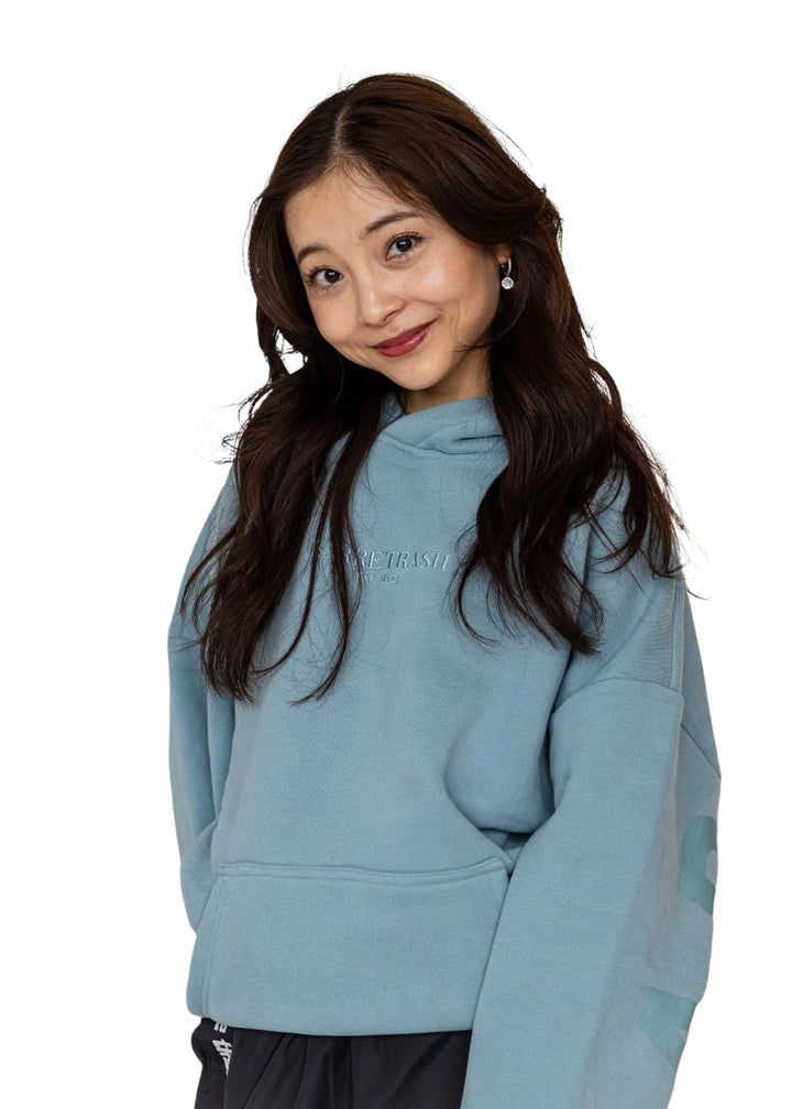 Barre Trash OH Oversized Hoodie in Powder Blue with tone-on-tone lettering, modeled by a ballet dancer