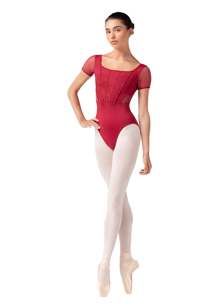 Bloch women's Olivia cap sleeve leotard in hot pink with corset seams, floral embroidery, and mesh sleeves.
