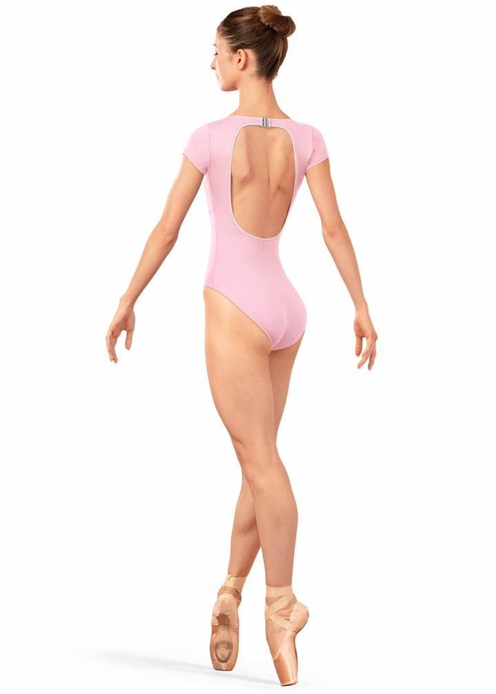 Bloch LB5262 Women's Alpheus Open Back Cut-Out with Clasp Closure Cap Sleeve Leotard in Carnation Light Pink with White Contrast Piping Detail, shown on a pointe dancer