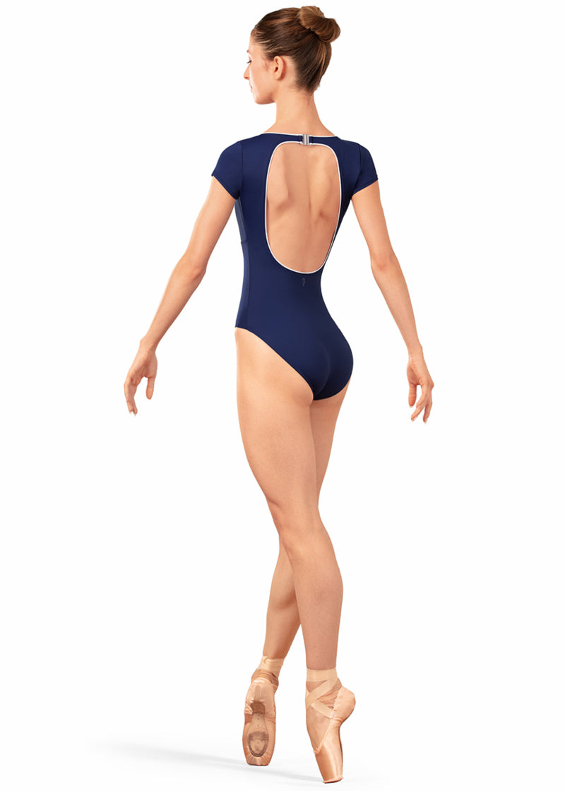 Bloch LB5262 Women's Alpheus Open Back Cut-Out with Clasp Closure Cap Sleeve Leotard in Navy Blue with White Contrast Piping Detail, shown on a pointe dancer