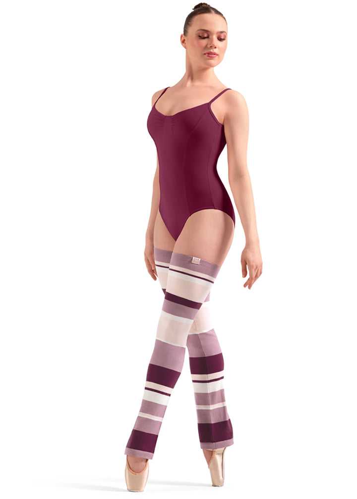 Bloch W11007 Women's Striped Thigh-High Legwarmers with Dark Pink, Light Pink, Peach, and Cream-colored Stripes with a relaxed fit ankle, shown on a pointe dancer