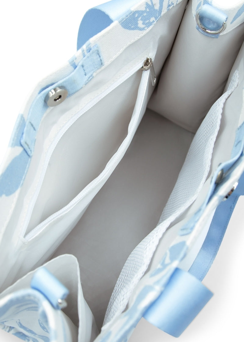 Interior view of the inner pockets and compartment of the Capezio B316 Women's Soho Canvas Tote Bag in white and light blue floral Suble Leaf Horizon print made with 100% cotton twill and grosgrain handles and detachable adjustable shoulder strap