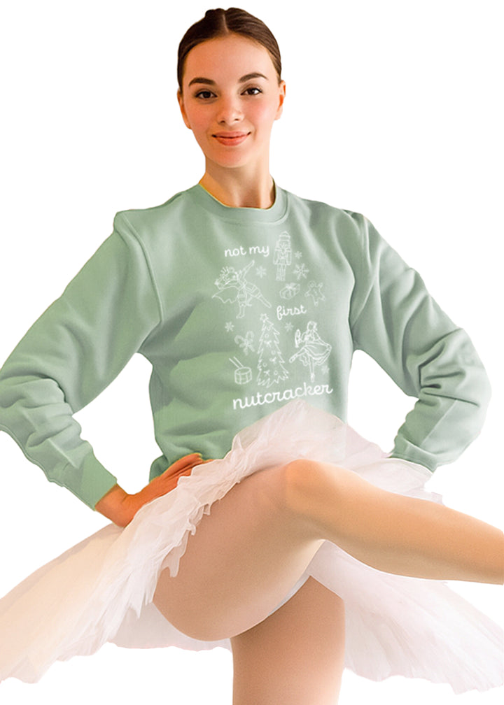 Covet Dance NMFN-SS Not My First Nutcracker Women's Crewneck Sweatshirt in Mint Green with Nutcracker Ballet-themed doodles printed in white, shown on a ballerina model wearing a white tutu