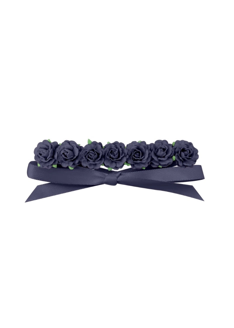 Seven dark blue flowers in a row, attached to a matching dark blue ribbon.