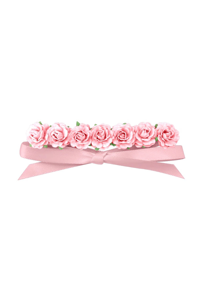 Light pink flowers attached to light pink ribbon.