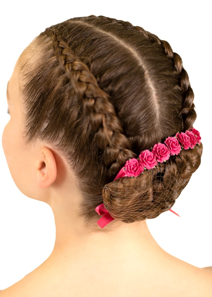 Pink flowers and ribbon tied around a ballerina's bun.