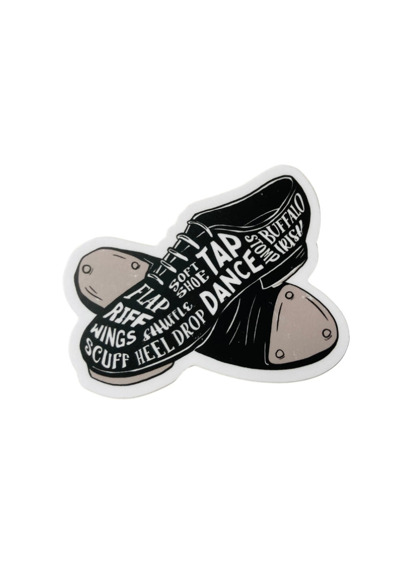 Black tap shoes with various tap dance terminology written on them in white.
