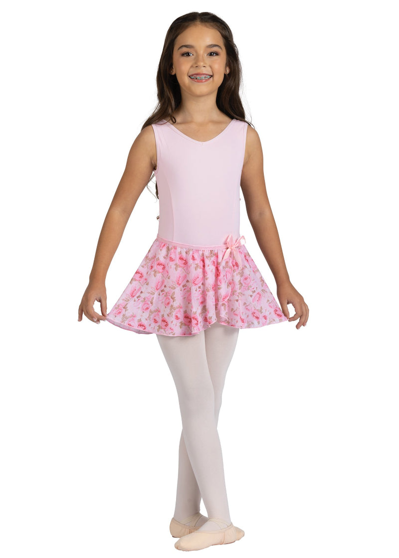 Danznmotion by Danshuz 25404C Girls' Rosetta Rose Floral Print Mock Wrap Georgette Youth Pull-On Skirt in Pink Pastel, shown on a young girl wearing a matching light pink leotard, pink tights, and pink ballet shoes