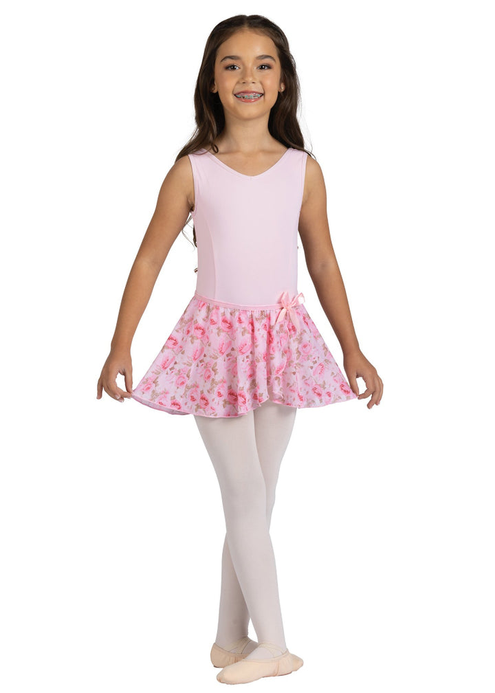 Danznmotion by Danshuz 25404C Girls' Rosetta Rose Floral Print Mock Wrap Georgette Youth Pull-On Skirt in Pink Pastel, shown on a young girl wearing a matching light pink leotard, pink tights, and pink ballet shoes