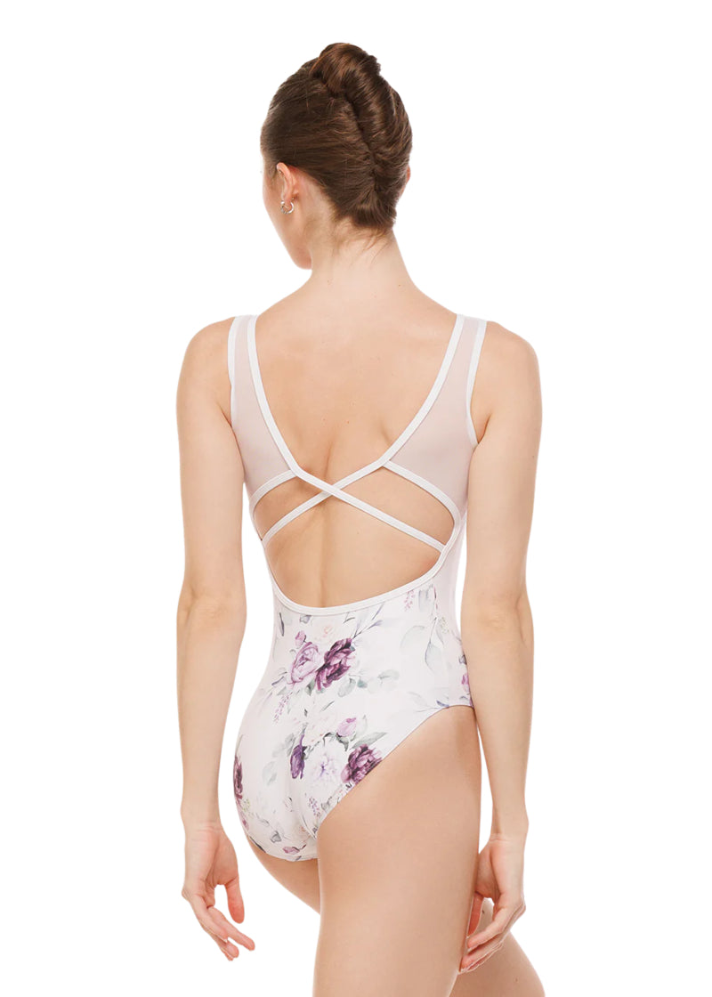 Eleve Dancewear Moonlit Garden Women's Fabiola Low-Cut Cross-Back Mesh Tank Leotard in white with all-over purple floral print, shown on a ballet dancer