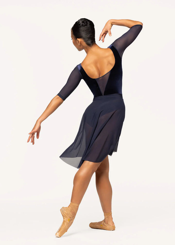 Eleve Dancewear Moonlit Garden Women's Tempe Leotard with mesh half-sleeves and velvet bodice in Eclipse navy blue, shown on a ballet dancer