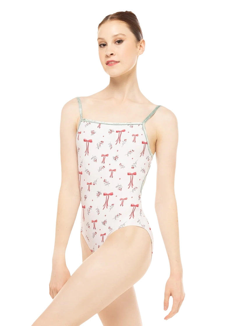 Eleve Candy camisole leotard in white with sage green velvet straps and a holiday themed pattern of red bows and holly