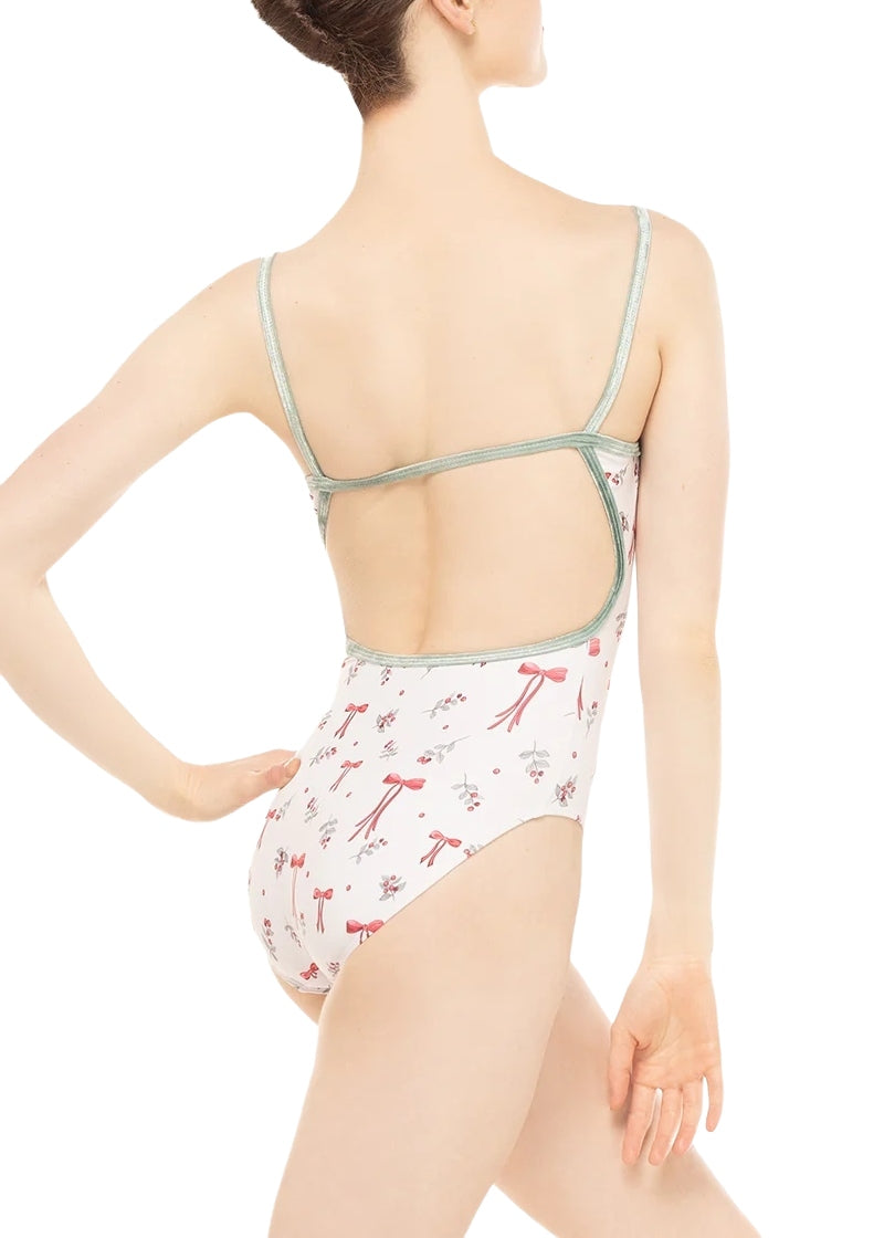 Eleve Candy camisole leotard in white with sage green velvet shoulder and back straps and a holiday themed pattern of red bows and holly