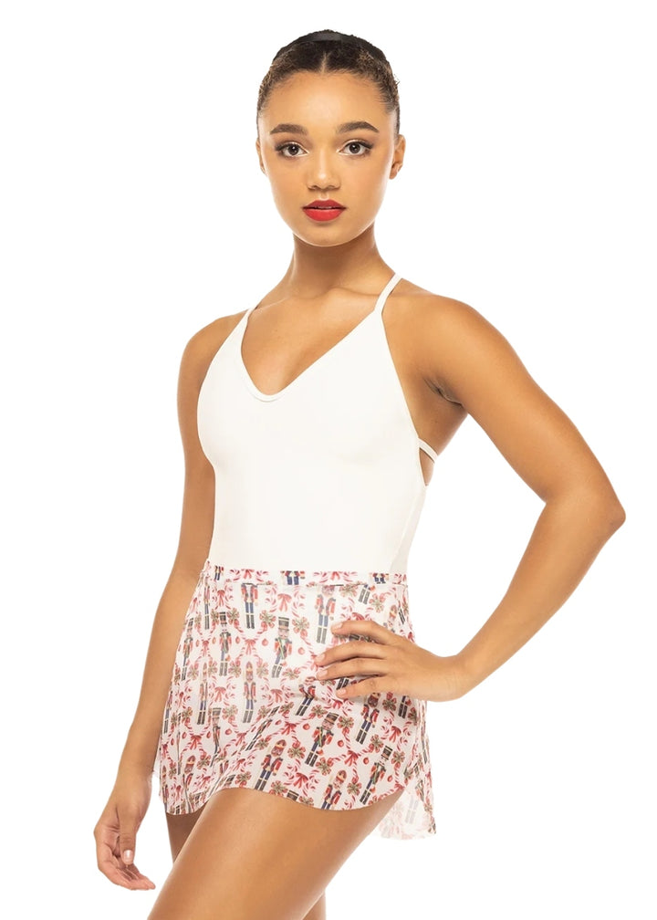 Eleve white mesh Tulip pull-on skirt with red and black nutcracker pattern with candy canes, pictured on a model wearing a white camisole leotard