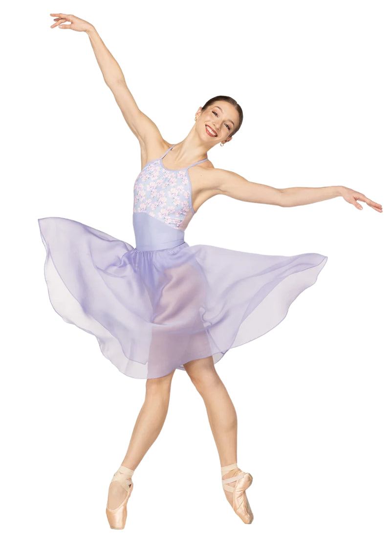 Eleve Dancewear Women's Ebony Floral Print Camisole Leotard in Garden Toss Multicolor with a Lavender Purple Base, modelled on a ballet dancer posing en pointe and wearing a matching skirt
