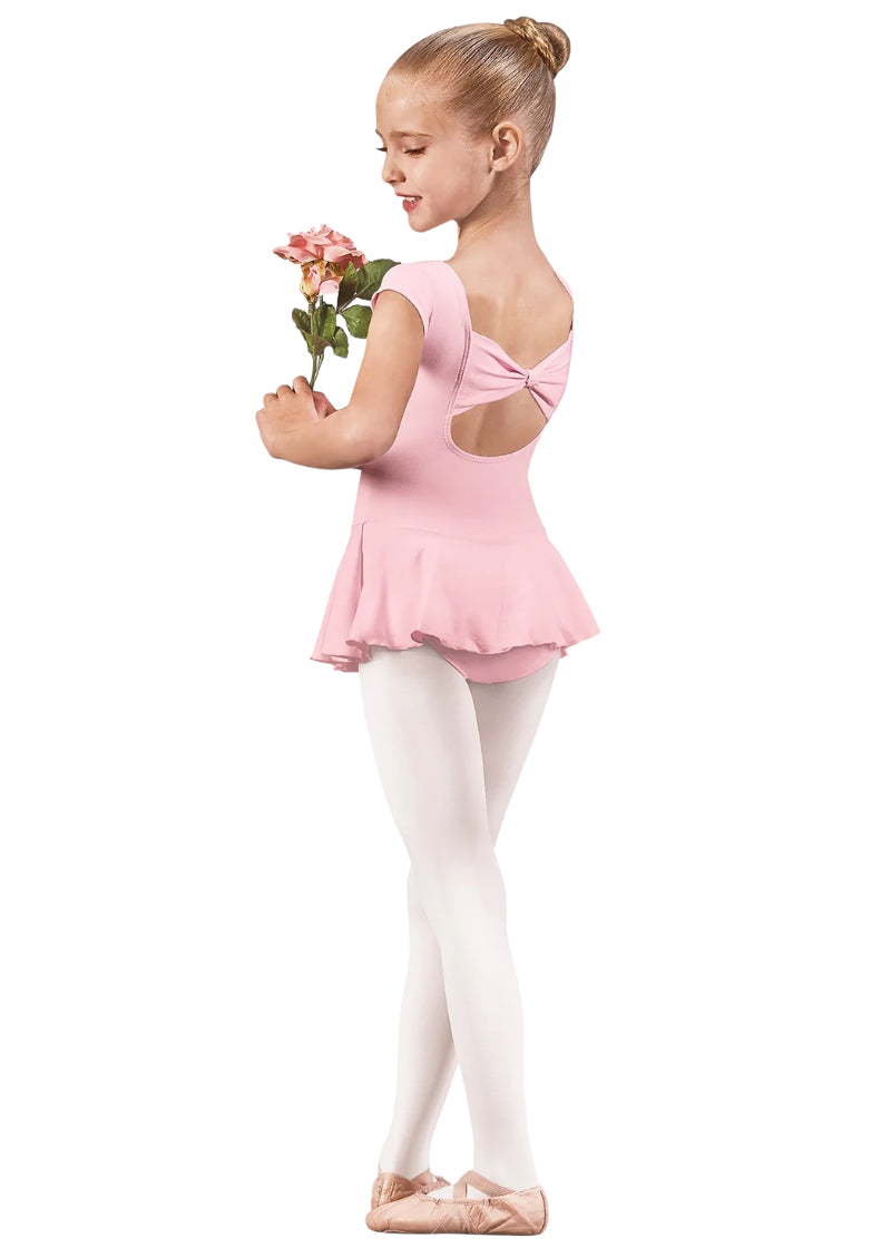 44285 Eurotard Girls Microfiber Bow Back Cap Sleeve Dance Dress in Pink, shown from the back on an adorable young dancer, who is holding a pink flower while standing in 5th position and looking over her left shoulder towards the viewer