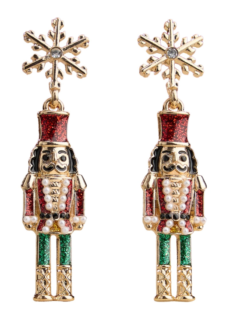 gold plated holiday nutcracker shaped earrings with red and green enamel hanging from a snowflake-shaped post