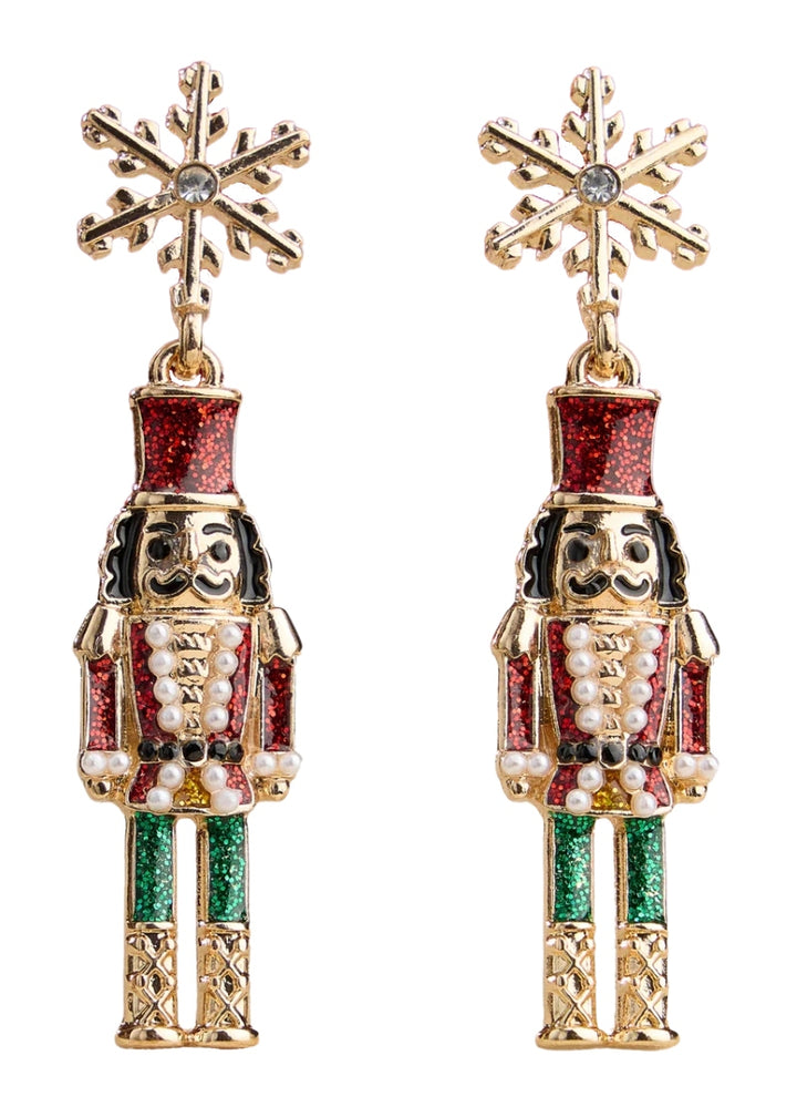 gold plated holiday nutcracker shaped earrings with red and green enamel hanging from a snowflake-shaped post