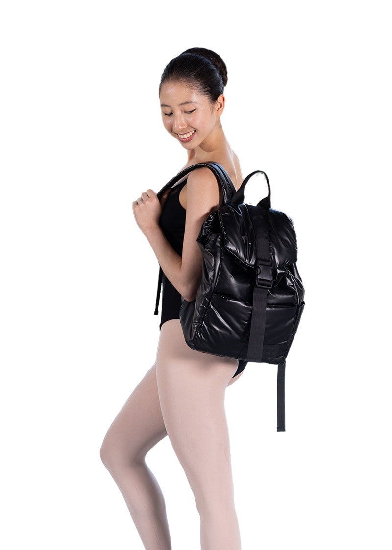 dancer holding a Nikolay black backpack with buckle closure