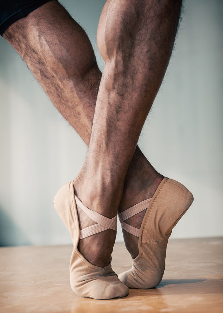 Orza Pro 2.0 Men's Split-Sole Canvas Ballet Shoe in Sand Light Skin Tone, shown on a male dancer