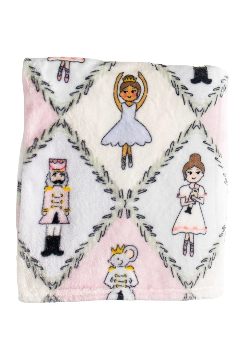 Fleece blanket with nutcracker character art in pastel argyle pattern.