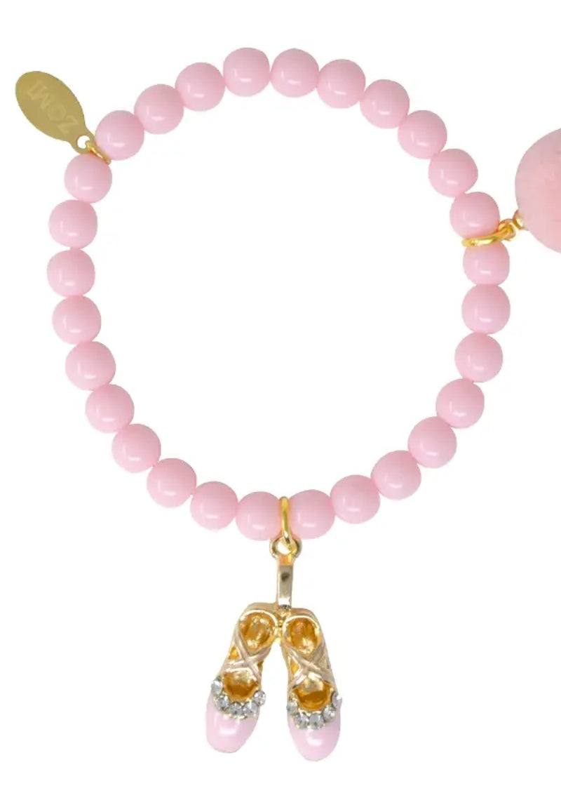 light pink beaded bracelet with pom-pom and ballet shoe charm