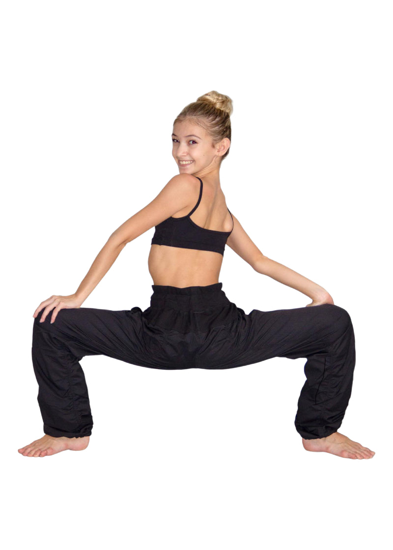 So Danca SP01 Girls' Studio Pants in Black with wide drawstring waistband and hem drawcords for a fully customizable fit, shown on a dancer