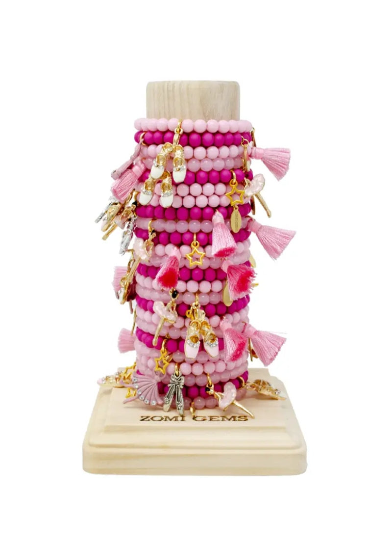 tower of beaded bracelets of various styles in shades of pink