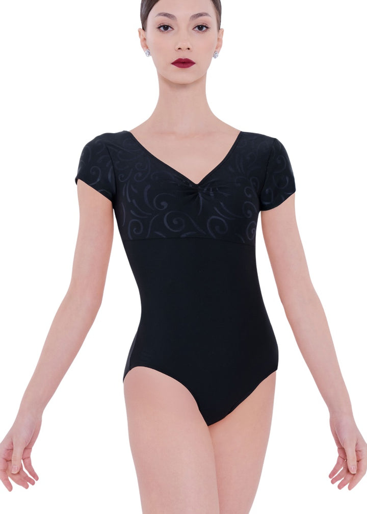 Wear Moi women's Elune short sleeve leotard in black with v-neckline, pinch front, and subtle swirl design on bust and sleeves.