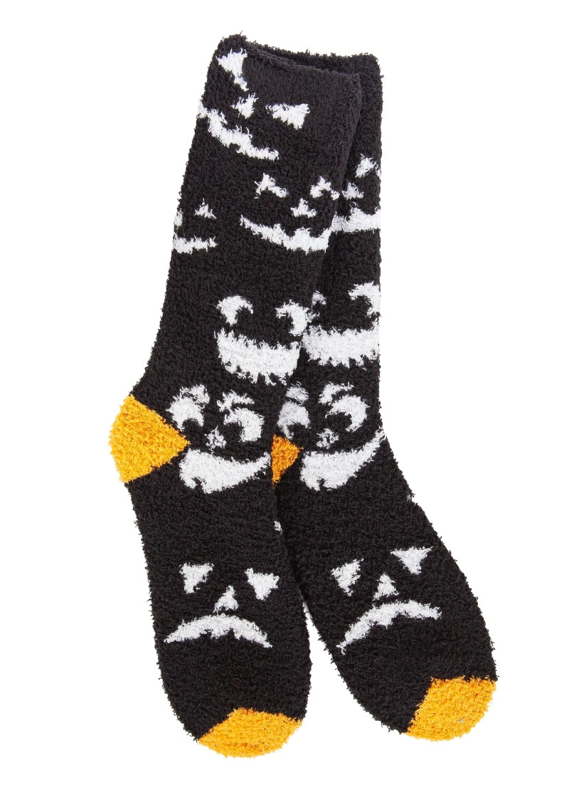 World's Softest Socks Knit Pickin' fuzzy crew socks in Spooky; black background with orange heel and toe and Jack-o-Lantern silhouette pattern