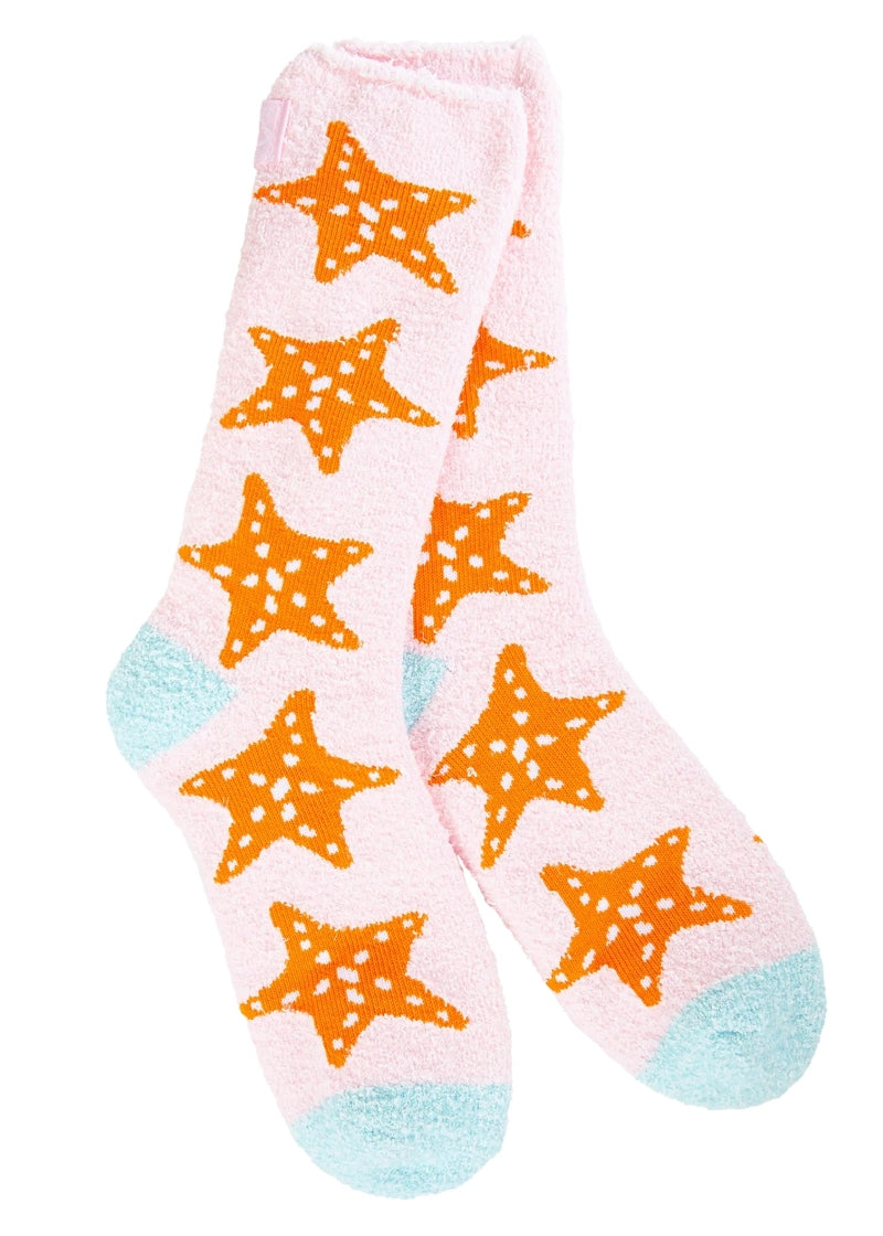 World's Softest Socks fuzzy socks in light pink with orange starfish pattern and blue heel and toe