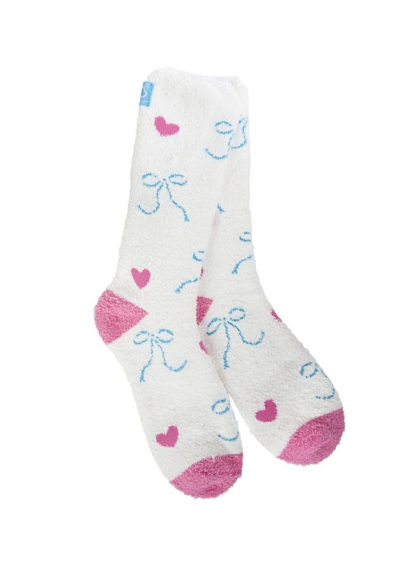 white fuzzy socks with pink hearts and blue bows